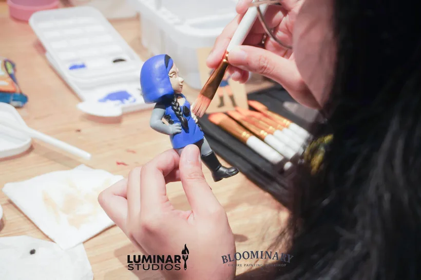 Participant painting a blue figure
